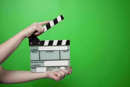 Un clap devant un fond vert